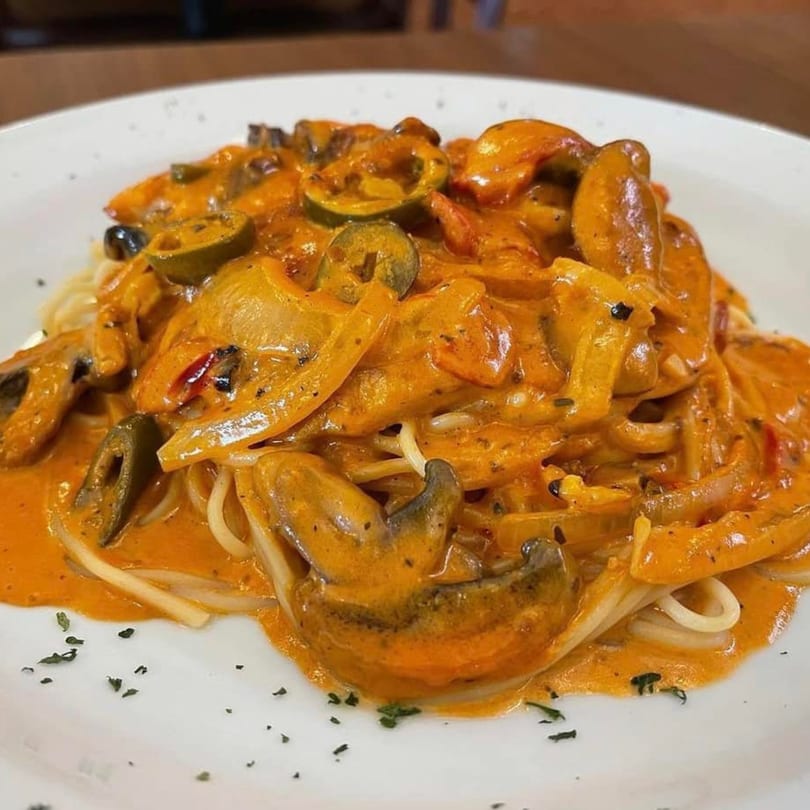 Genova's Italian Restaurant's spaghetti with creamy orange sauce, mushrooms, and sliced green peppers.